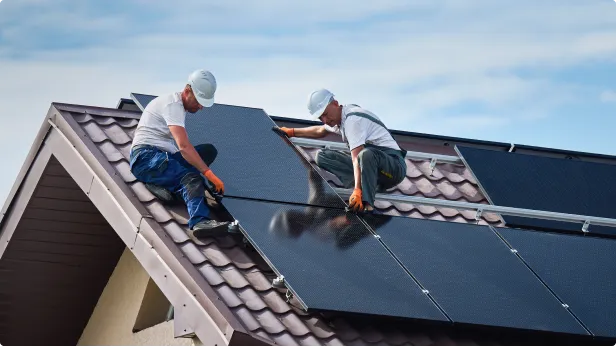 Homens instalando estrutura de paineis solares em uma casa